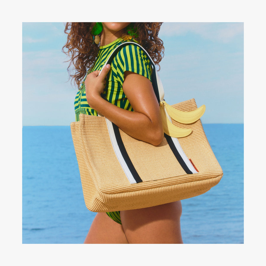 Banana | Woman standing by the ocean holding a Canopy Tote with a banana charm