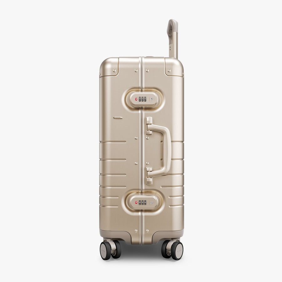 Champagne Gold | Side view of Aluminum Carry-On Plus in Champagne Gold