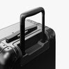 Extended luggage handle view of Aluminum Carry-On Plus in Caviar Black (thumbnail)