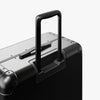 Extended luggage handle view of Aluminum Check-In Large in Caviar Black (thumbnail)