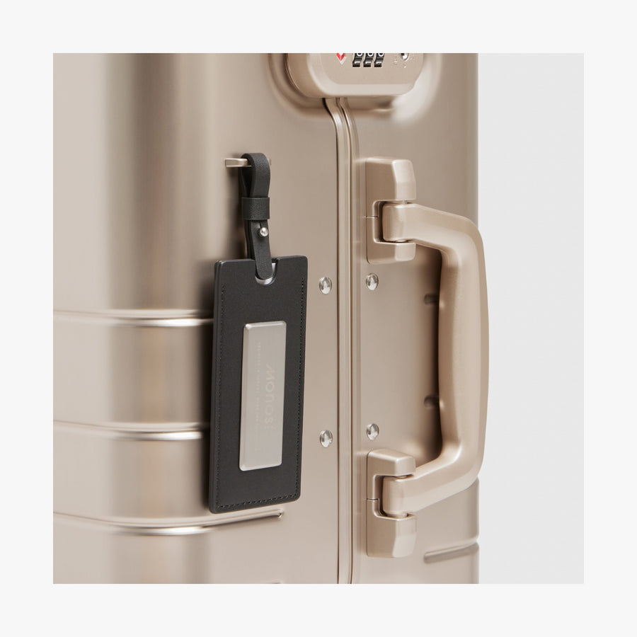 Champagne Gold | Luggage tag view of Aluminum Carry-On Plus in Champagne Gold