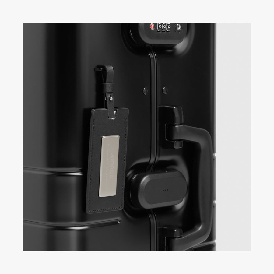 Caviar Black | Luggage tag view of Aluminum Check-In Medium in Caviar Black