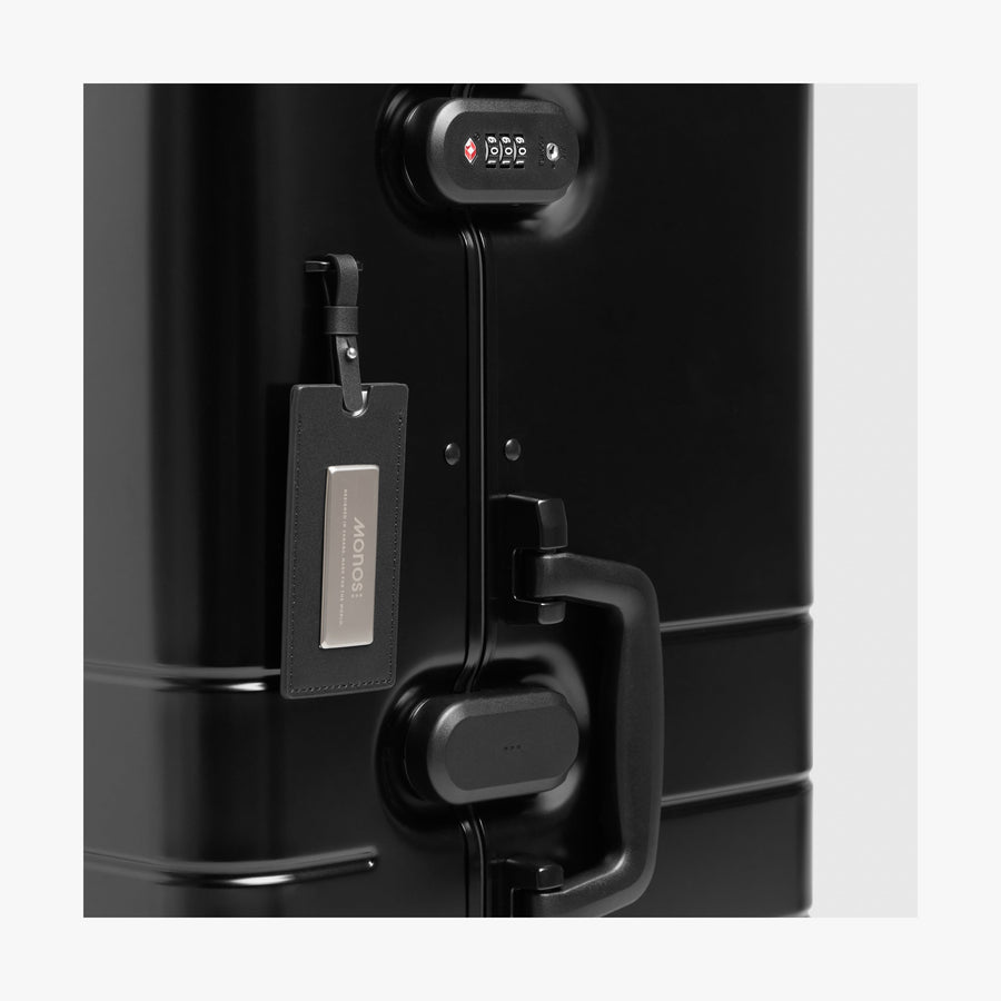 Caviar Black | Luggage tag view of Aluminum Trunk in Caviar Black