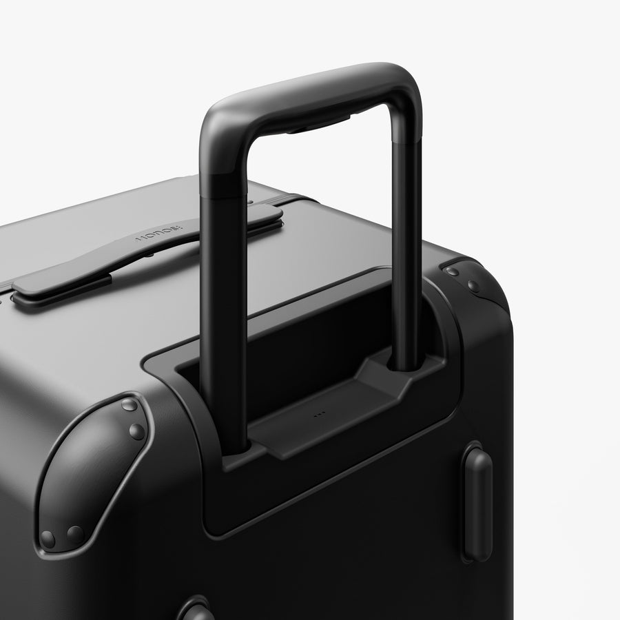 Obsidian | Extended luggage handle view of Hybrid Trunk Medium in Obsidian