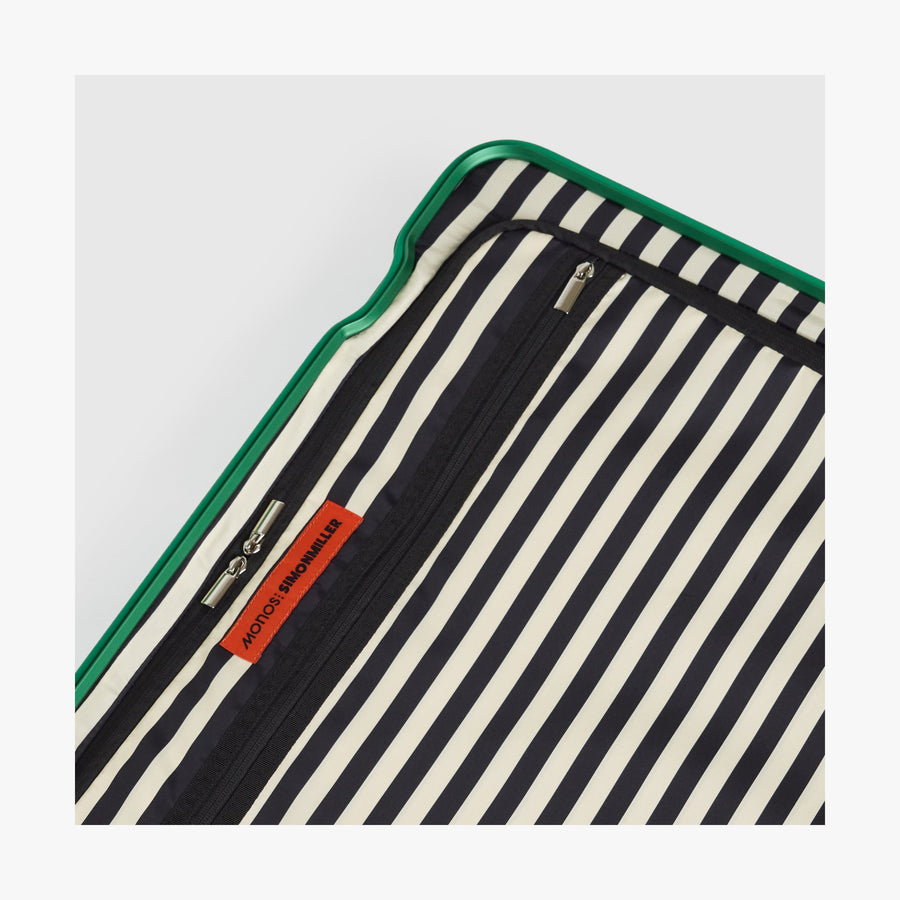 Jungle Green | Close-up view of the Hybrid suitcase interior in Jungle Green, featuring the Poplin Stripe Jungle Green zipped compartment