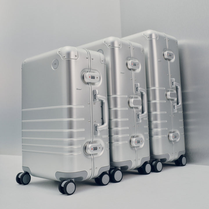 The Aluminum Luggage Collection in Aspen Silver — featuring the Carry-On, Check-In Medium, and Check-In Large, crafted for timeless durability and elevated travel.