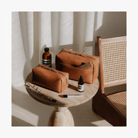 Lifestyle image showing the Metro Toiletry Case Large and Small in Saddle Tan (thumbnail)