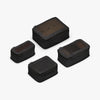 This is a photo of a set of four compressible packing cubes in black (thumbnail)