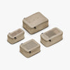 This is a photo of a set of four compressible packing cubes in tan (thumbnail)