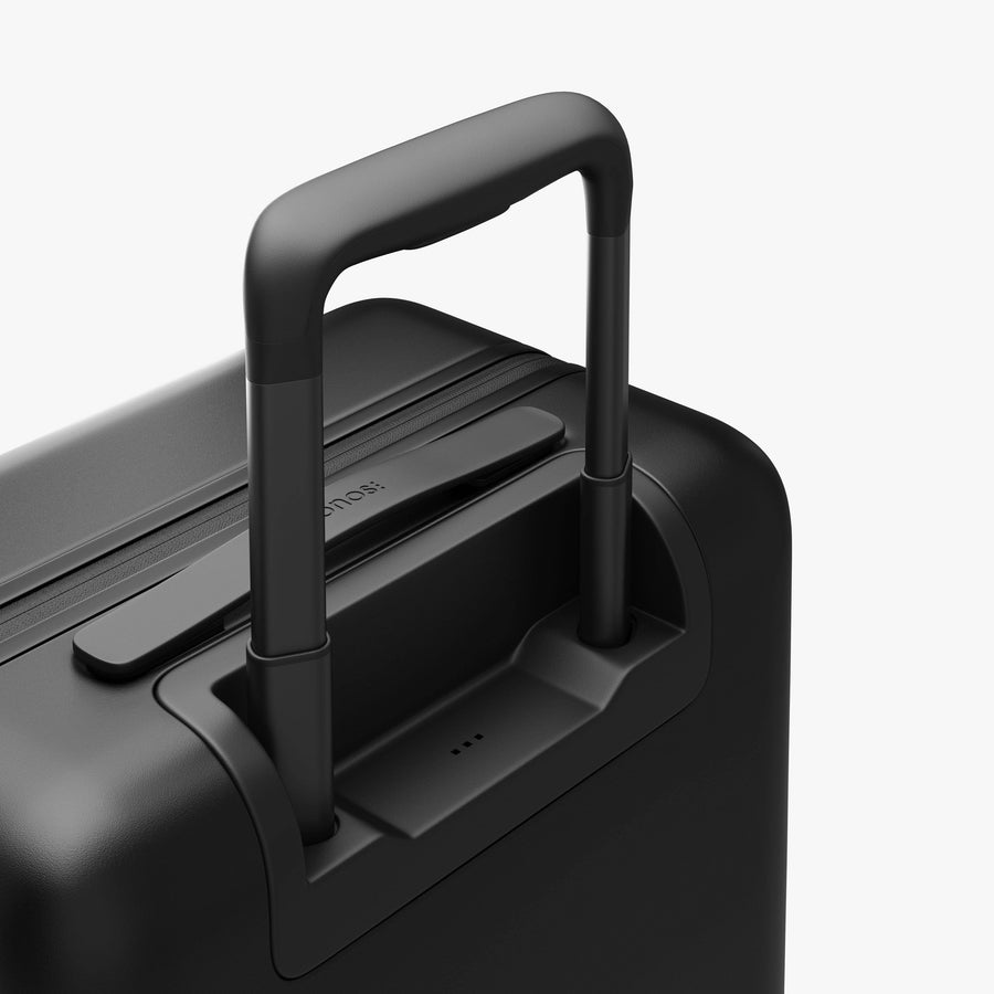Midnight Black | Extended luggage handle view of Carry-On Plus in Midnight Black