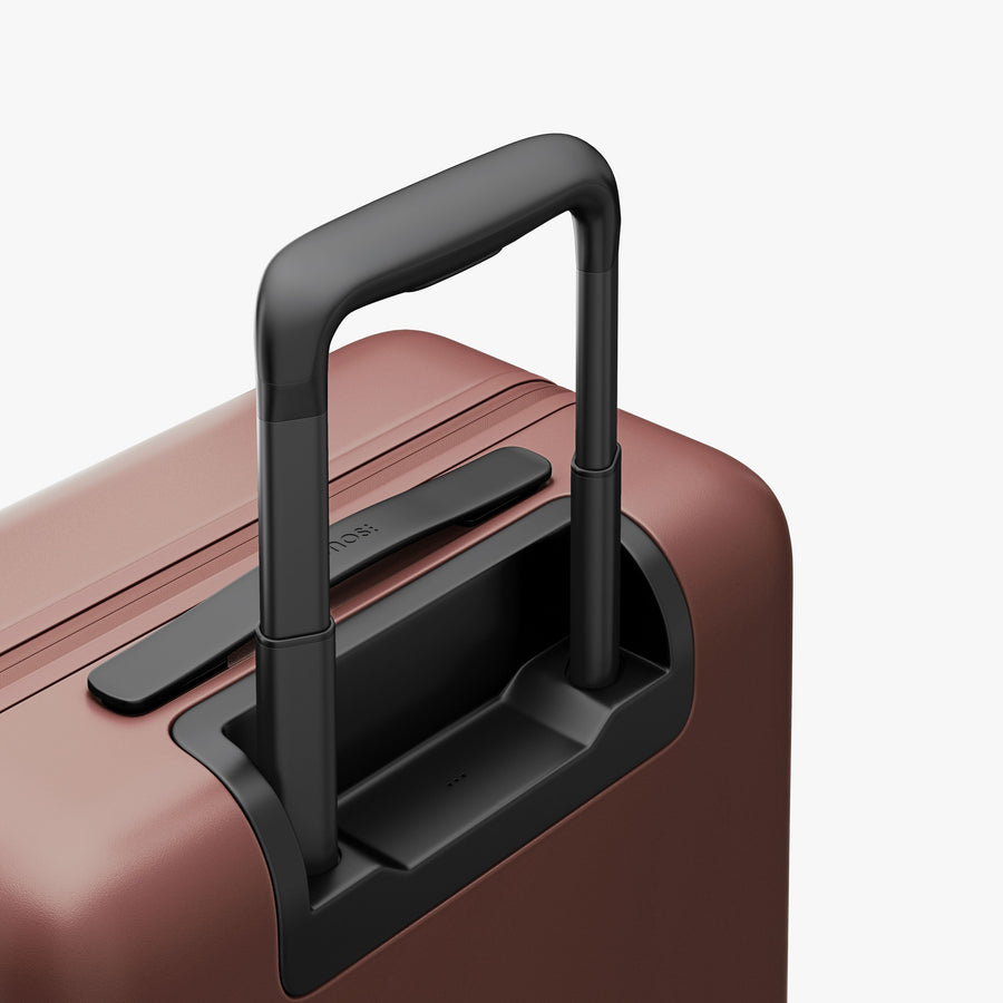 Terracotta | Extended luggage handle view of Carry-On Pro in Terracotta