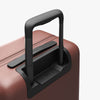 Extended luggage handle view of Carry-On Plus in Terracotta (thumbnail)