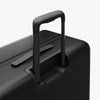 Extended luggage handle view of Check-In Large in Midnight Black (thumbnail)