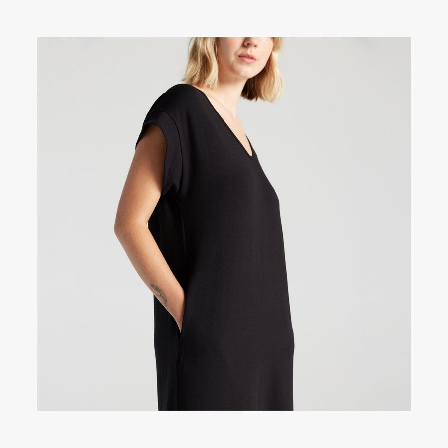 Black | Side pocket view of woman in Sevilla Dress Black